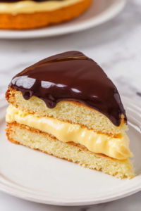 Tender yellow cake layered with creamy filling and finished with a thick chocolate glaze.