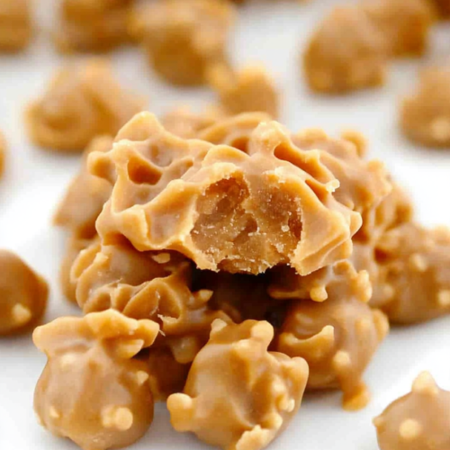 A batch of homemade candy bites arranged on parchment paper, showing their uneven, rustic shapes.