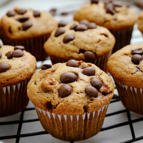 Warm baked treats with visible chocolate chips and coffee accents, presented in a casual style.