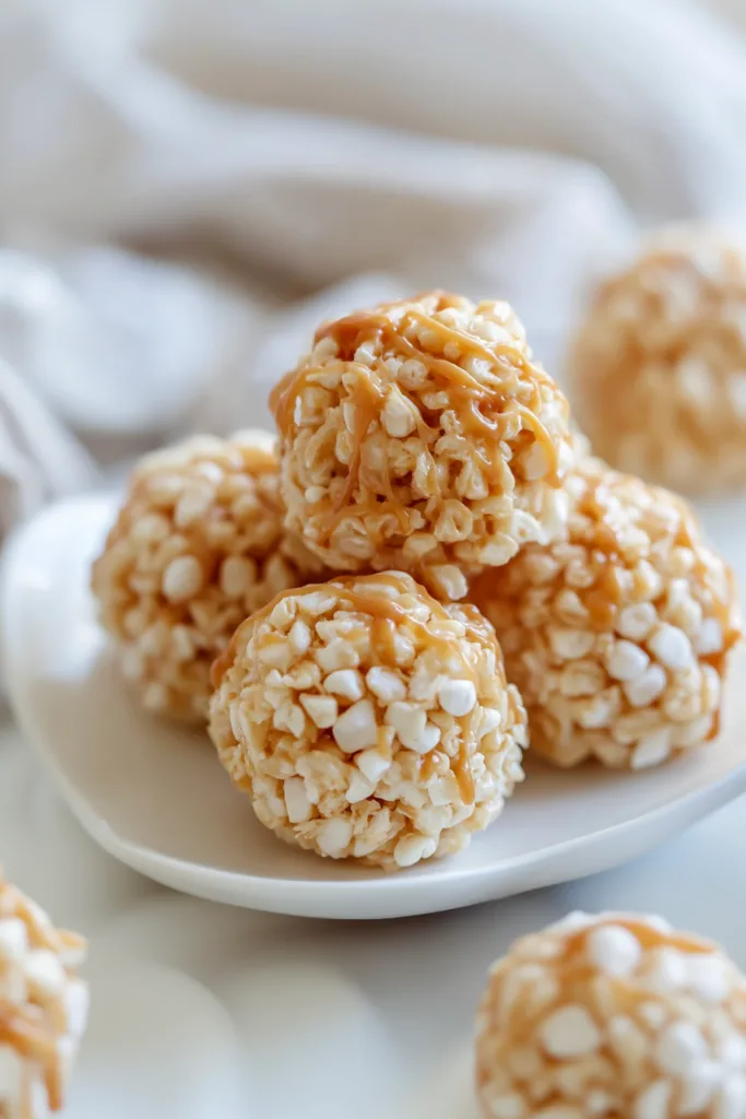 Sweet marshmallow cereal treats shaped into round bite-sized balls and arranged on a serving dish.