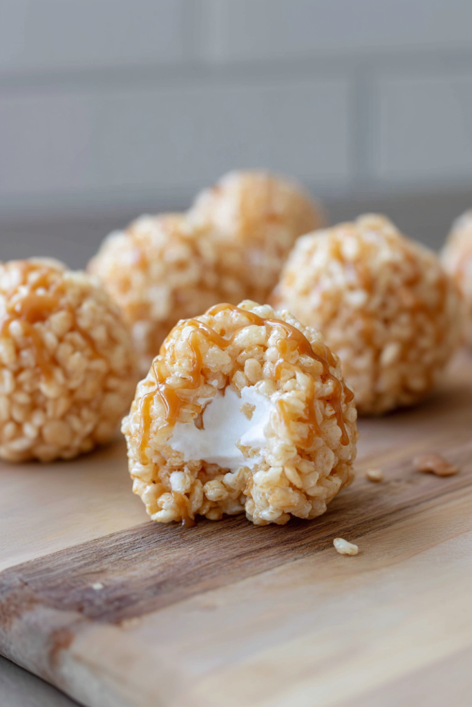 Golden crispy rice dessert balls with a glossy caramel finish, photographed in natural light.