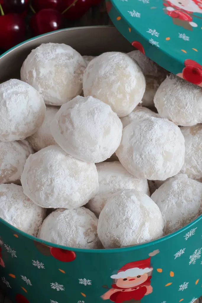Buttery snowball cookies dusted generously in confectionersโ sugar and arranged for serving.