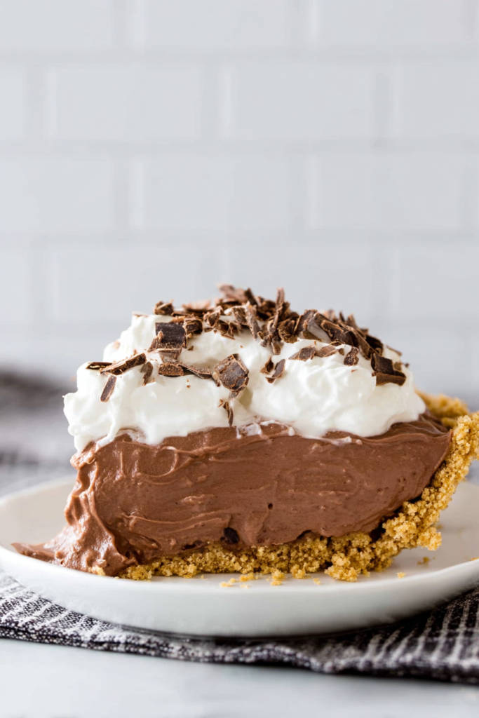 Homemade chocolate dessert pie finished with chocolate curls and smooth pudding filling