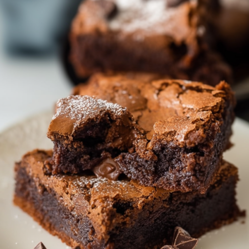 A rich pumpkin cheesecake topped with a dark chocolate spiderweb design, sliced and ready to serve.
