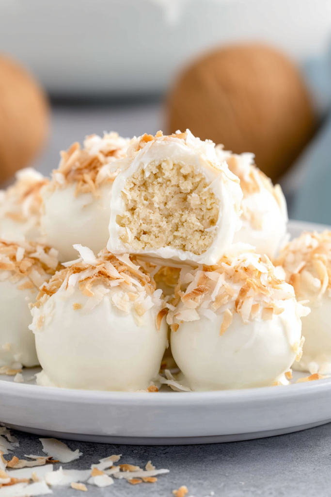 Plate of bite-sized desserts styled with coconuts in the background for a tropical feel
