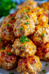 Rustic platter of browned sausage balls styled with herbs for garnish