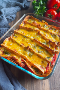 Cheesy layered tortilla bake with golden brown tops and colorful peppers and tomatoes.