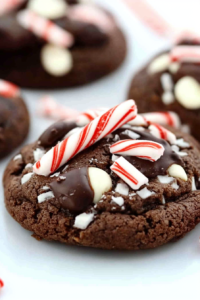 Soft chocolate cookie topped with crushed candy canes, white chocolate chips, and a drizzle of melted dark chocolate.