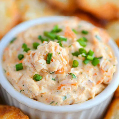 Hot and creamy appetizer dip filled with crab and spices, ready for serving.