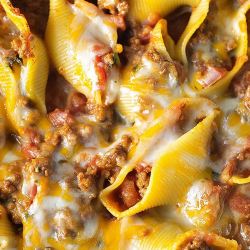 Close-up of cheesy stuffed pasta shells fresh from the oven.