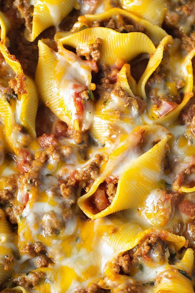 Close-up of cheesy stuffed pasta shells fresh from the oven.