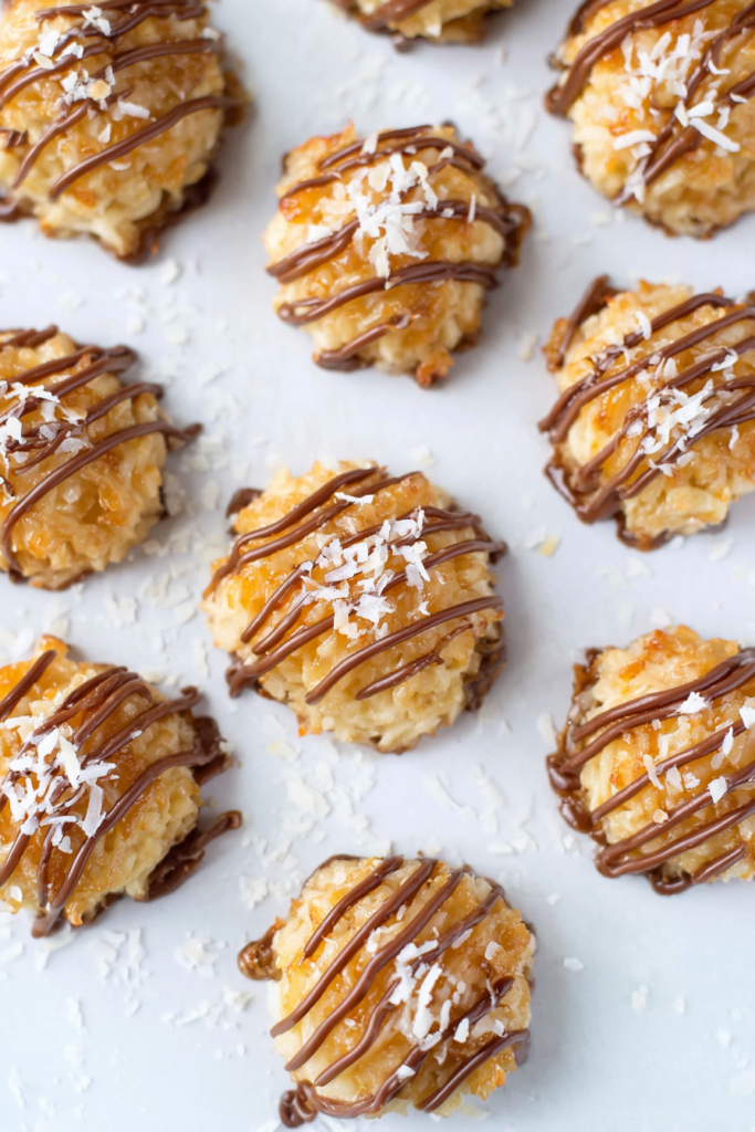 Sweet coconut treats with toasted edges and melted chocolate drizzle.