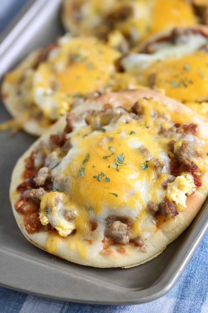 Close-up of a freshly baked breakfast-style pizza with golden cheese and savory toppings.
