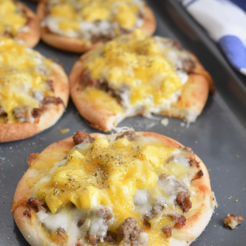 Homemade savory pizza topped with cheese and herbs, served warm from the oven.