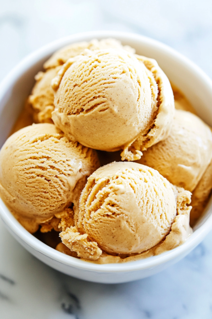 Smooth autumn ice cream scoops packed with warm spice flavor and cookie bits.