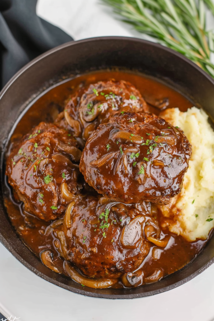 Juicy beef patties in mushroom‑onion gravy with mashed potatoes