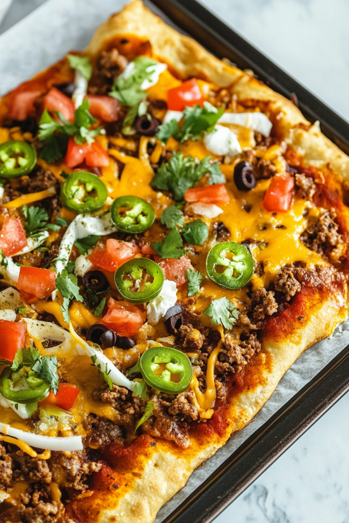 Golden crust topped with melted cheddar, seasoned beef, and fresh cilantro, served straight from the sheet pan.