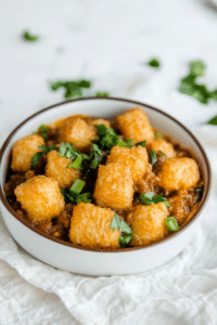 Comfort food casserole with a crunchy potato crust and savory layers beneath.