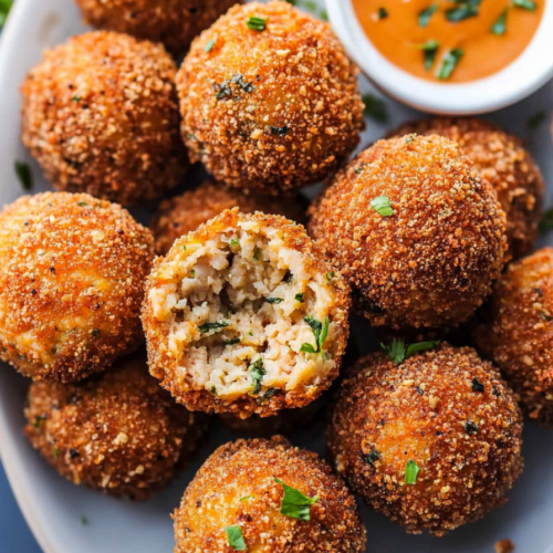 Close-up of fried boudin balls showing crunchy coating and moist interior with herbs.