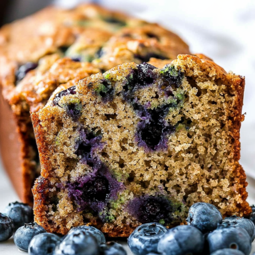 Rustic loaf packed with blueberries, showcasing a soft and fluffy texture