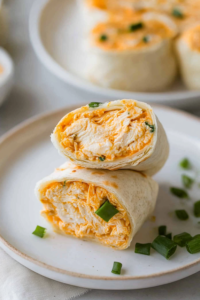 Stacked pinwheels highlighting the vibrant orange filling and fresh garnish.