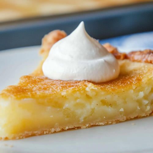 Pie portion plated neatly, showing the contrast between flaky crust and soft custard center.