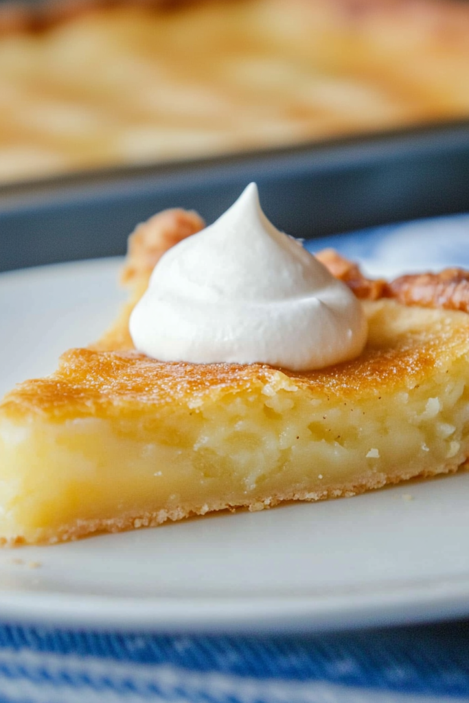 Pie portion plated neatly, showing the contrast between flaky crust and soft custard center.
