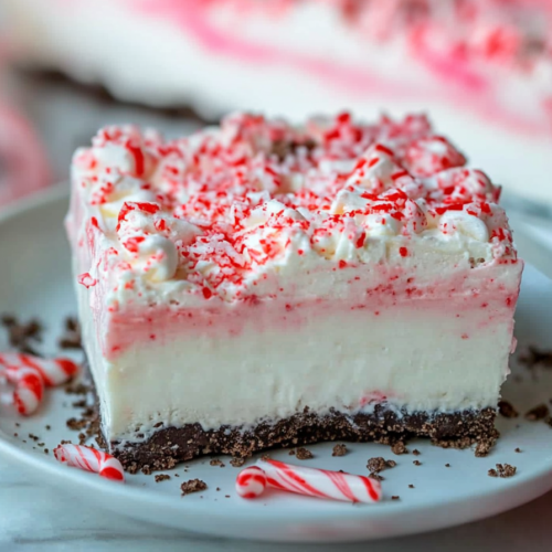 No-bake layered peppermint dessert with chocolate cookie crust and whipped topping.