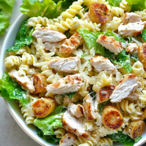 Hearty pasta and chicken salad tossed with lettuce and parmesan