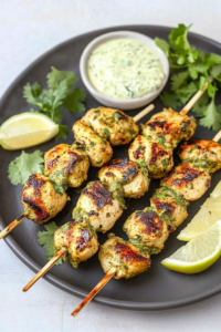 Juicy chicken skewers served with a creamy dipping sauce and lime wedges