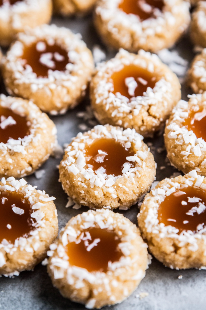 Festive cookies arranged neatly, showing coconut-coated edges and smooth caramel filling.