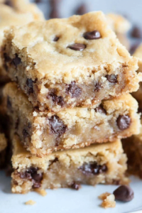 Close-up of chewy dessert bars highlighting their crumbly texture and rich chocolate filling.