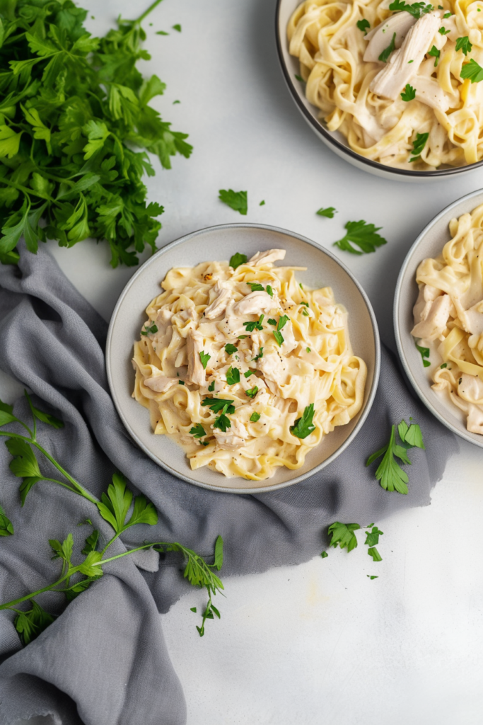 Classic Italian-American dish featuring creamy noodles and rotisserie chicken, finished with fresh herbs.