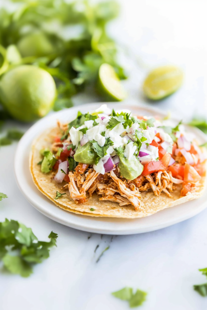 Golden tostada shell topped with juicy chicken and colorful fresh toppings ๐ฎ