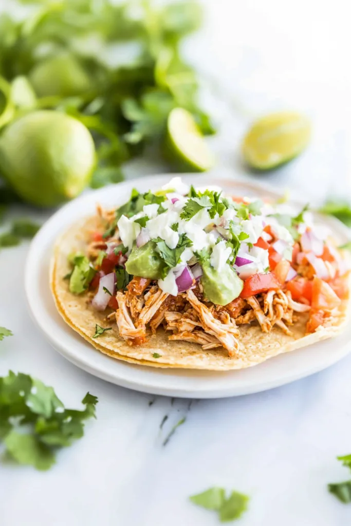 Golden tostada shell topped with juicy chicken and colorful fresh toppings ๐ฎ