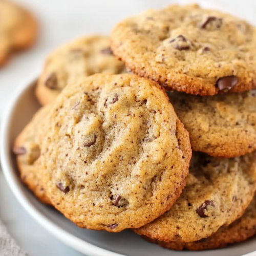 Final presentation of fluffy banana cookies, plated simply to emphasize their soft, airy texture.