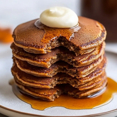 Warm spiced breakfast pancakes served with melted butter and maple syrup.