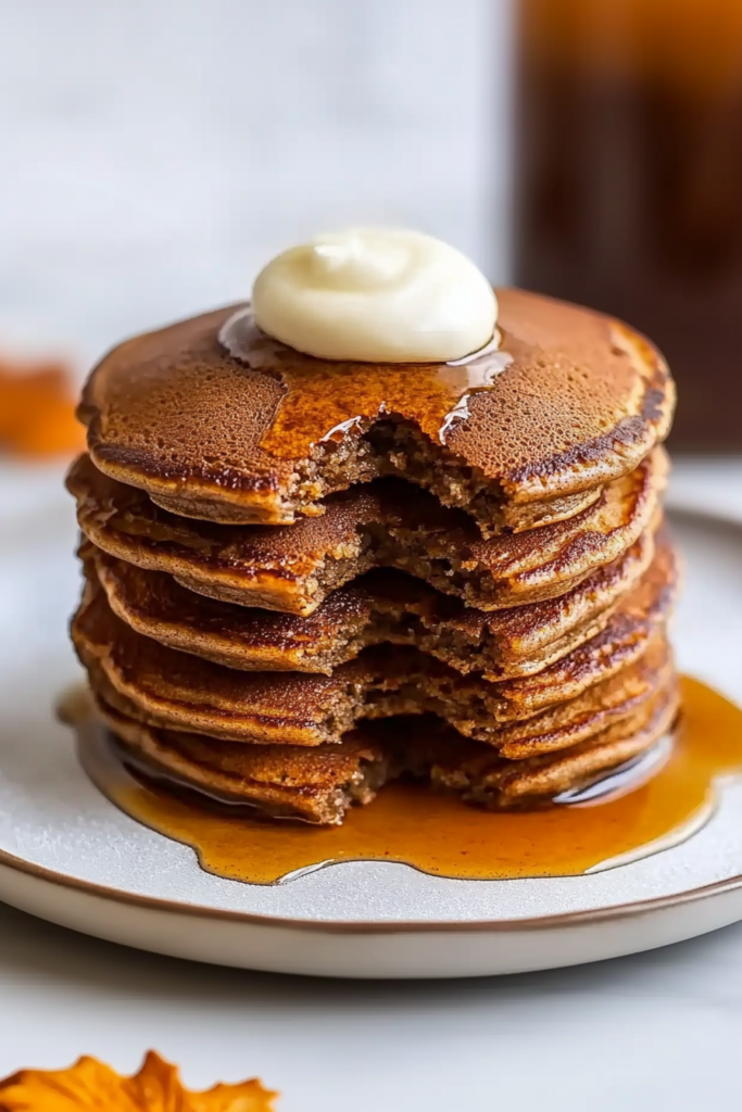 Warm spiced breakfast pancakes served with melted butter and maple syrup.