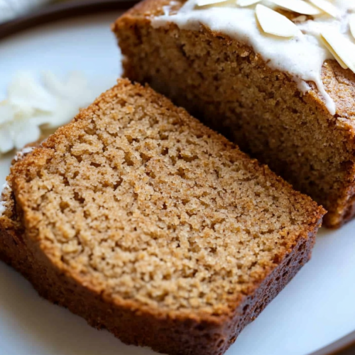Freshly baked rustic spice loaf with warm brown color and nut topping.