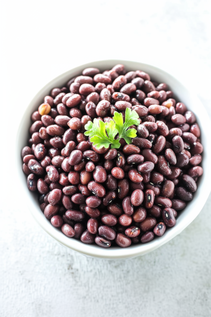 Final dish of tender adzuki beans, garnished lightly with herbs for a fresh finish.