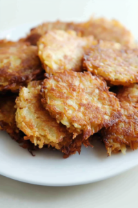 Latkes arranged neatly, emphasizing their rich color and homestyle appeal.