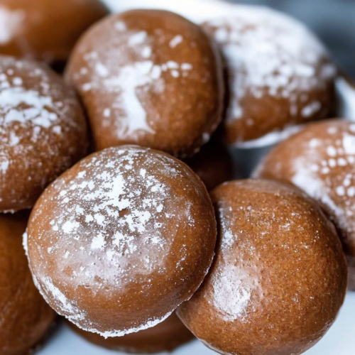 Homemade German Christmas spice cookies arranged on parchment paper with one cookie split to show texture.