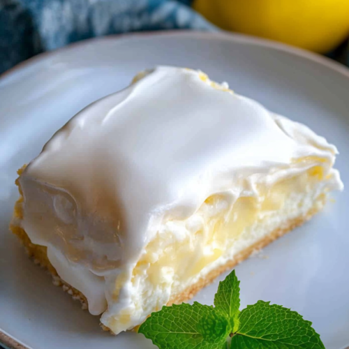 Refreshing layered lemon cream cake with a soft crust and smooth citrus filling.