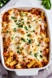 Freshly baked ziti casserole with tomato sauce and melted cheese ready to serve.
