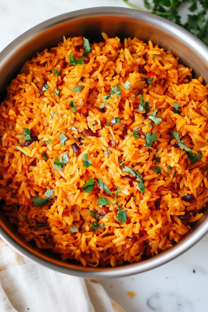 Close-up of seasoned rice with peppers, herbs, and a vibrant orange color