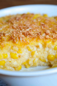 Close-up of creamy corn pudding showing whole kernels beneath its browned crust.