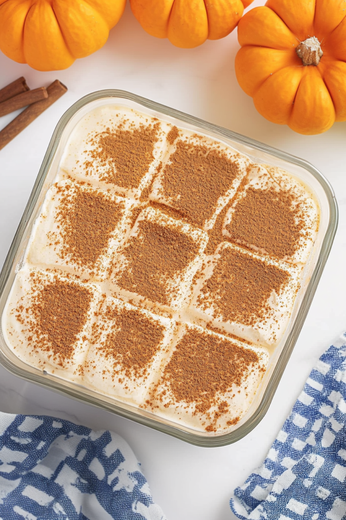 Festive autumn dessert served with whipped cream and dusted spice.