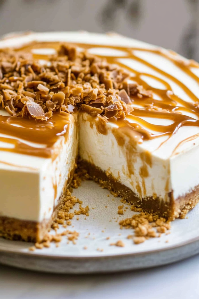 Rich dessert with layers of cheesecake and crust, finished with glossy caramel and chopped candy.