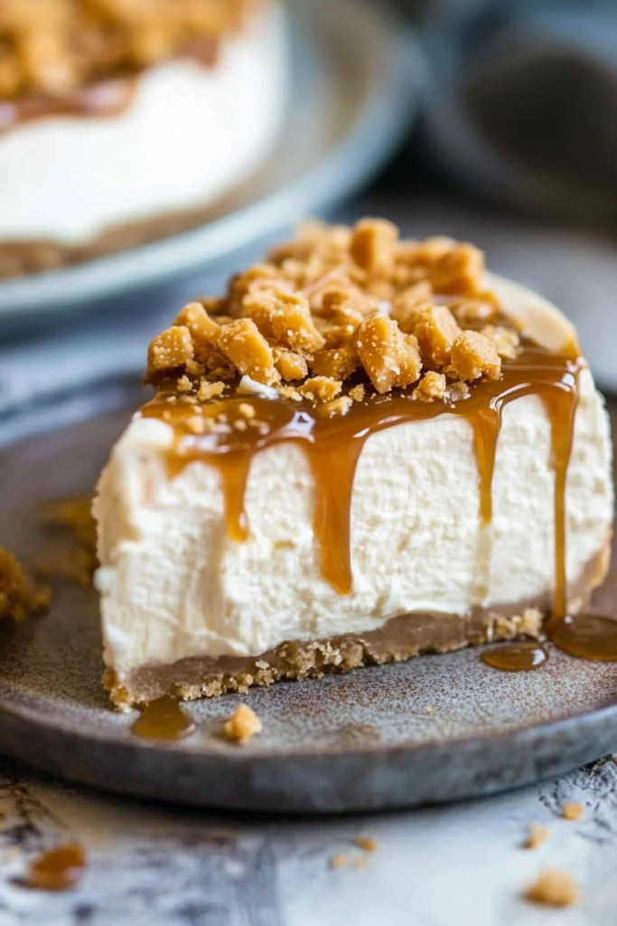 Close-up of a sliced cheesecake showing its smooth filling, crumbly crust, and caramel topping.