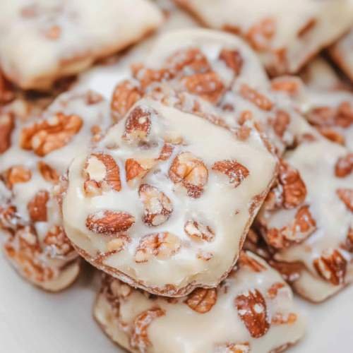 Sweet nut-filled squares stacked together, showcasing their shiny finish.